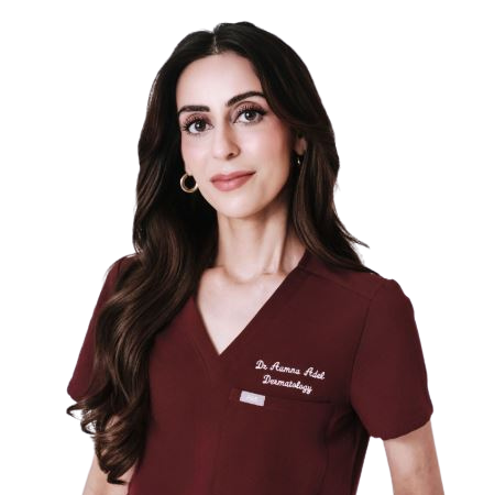 Woman wearing a maroon scrub top against a white background