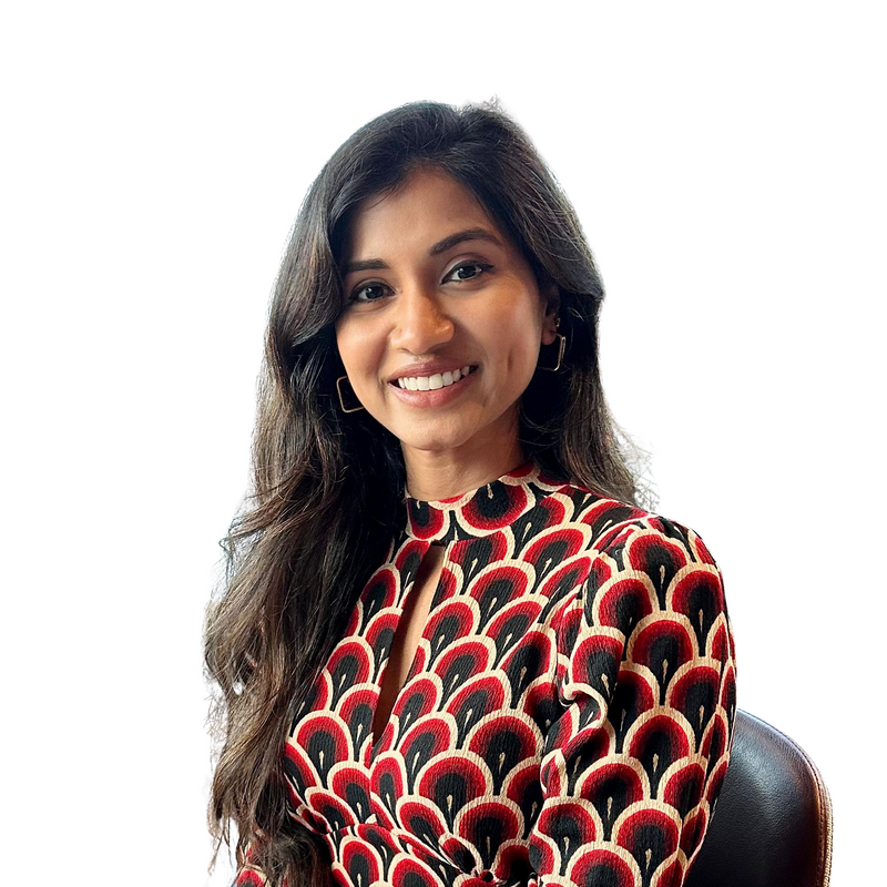 Woman wearing a patterned top with a plain background